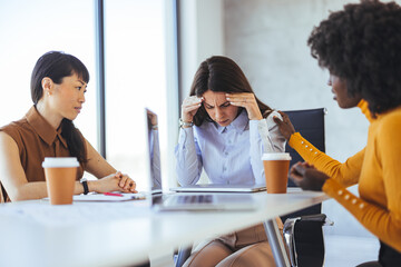 Supportive Colleagues Comforting Stressed Coworker in Office Meeting