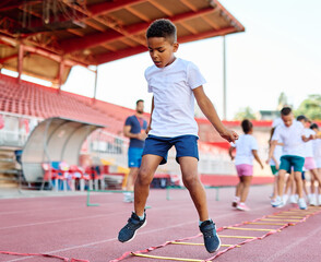 child sport athlete childhood girl competition fun young outdoor active exercise kid running fitness training athletic game healthy group play team school exercising jump © Lumos sp