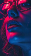 Close-up portrait of a woman with blue lips and red and blue light reflecting on her face.