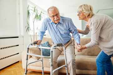 Fototapeta premium support woman man problem couple senior pain patient walker nursing caregiver health caucasian disabled disability elder pensioner care backache back health help