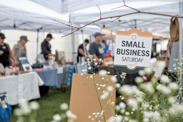 Small Business Saturday Outdoor Market with Vendor Booths and Shoppers Image