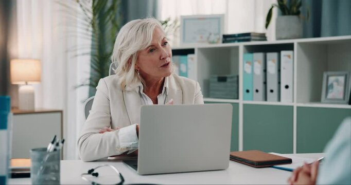 Mature, doctor and talking to patient in office with laptop for medical results and healthcare screening test. Professional, consultation and woman expert with appointment feedback, advice or support