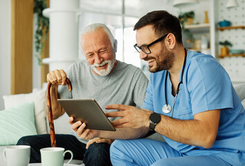 nurse doctor senior care tablet computer technology showing caregiver help assistence retirement...