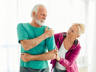  senior stretching exercise woman training sport fitness home gym exercising man couple pain shoulder injury back care health fit ache joint painful muscle backache problem medicine painful
