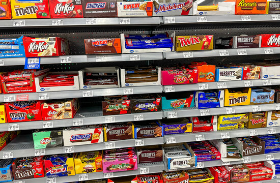 Assortment of chocolate candy bars and candy on an American supermarket shelf.
Valparaiso, IN, USA September 13, 2024