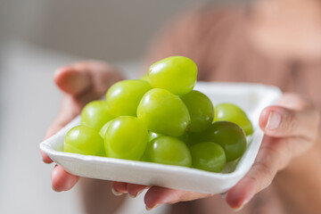Woman Holding Fresh Green Grapes