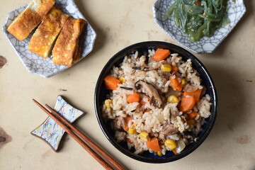 Takikomi Gohan is a Japanese rice dish with short-grain rice with vegetables, mushrooms, seafood, or meat. Often served with rolled egg omlette tamagoyaki