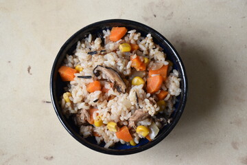 Takikomi Gohan is a Japanese rice dish with short-grain rice with vegetables, mushrooms, seafood, or meat. Often served with rolled egg omlette tamagoyaki