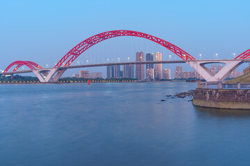 Naklejka premium Guangzhou Pearl River Red Bridge and Riverside City Tall Buildings