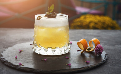 Cocktail on rustic wood background. Cold citrus alcohol beverage with tequila, blood juice and ginger beer, served with citrons and ice, copy space