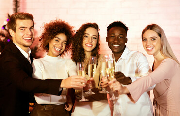Christmas Corporate Party. Cheerful Coworkers Clinking Champagne Glasses Celebrating Xmas Standing Indoors