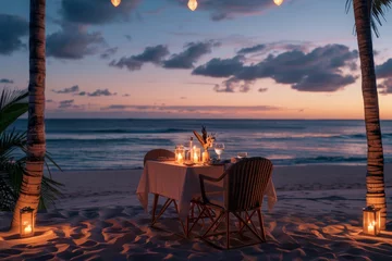 A romantic dinner on a beach with a table and chairs set up