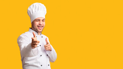 I Choose You. Cheerful Chef Man Pointing Fingers Winking At Camera Standing On Yellow Background....