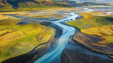 A bird's-eye view of a glacier river in Iceland. The river's colors and streaks look like a painting on the landscape.