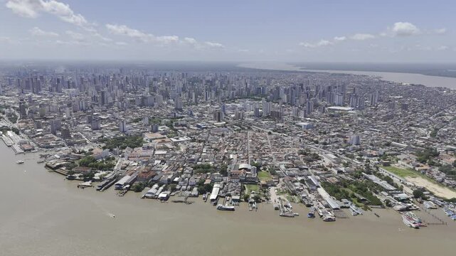 Drone orbits to the left high over downtown Bel&eacute;m on sunny afternoon in the north of Brazil