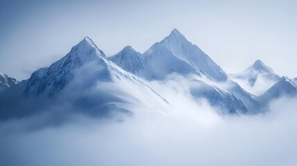 Fototapeta premium Majestic Snowy Peaks Shrouded in Ethereal Mist Captivating Mountainous Landscape
