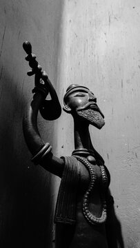 Wooden statue of a Baul, group of Vaishnava Hindus and Sufi Muslims. They are identified by their distinctive clothes and musical instruments. Lalon Shah is regarded as the most celebrated Baul.India.