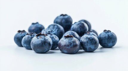 A close-up of fresh blueberries arranged on a light background.