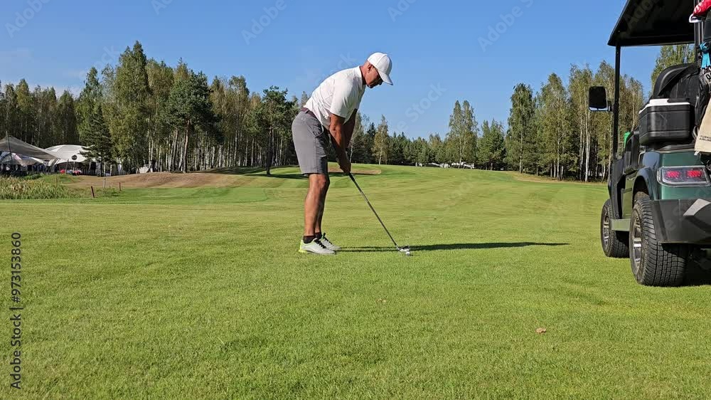 Wall mural golfing on a sunny afternoon at the beautiful course with a perfect swing and a focus on precision