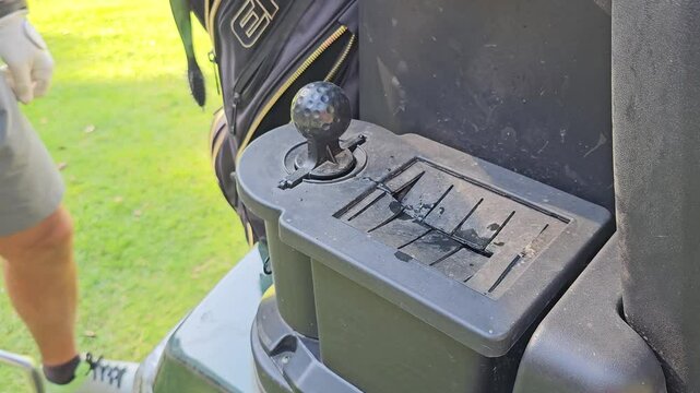 Golfer cleans golf clubs. Golf club care and cleanliness concept