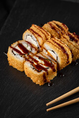 Elegant Tempura Roll with Unagi Sauce and Shrimp Close-Up on Black Slate, Minimalist Presentation, Warm Lighting