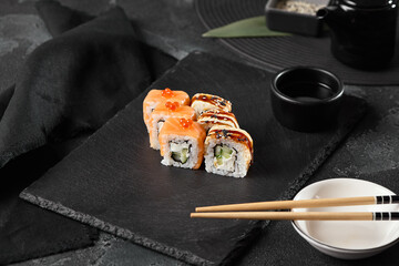 Elegant Sushi Presentation with Salmon and Eel Rolls on Slate Plate