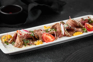 Gourmet Beef Roast Beef Platter with Tomatoes and Microgreens in Elegant Fine Dining Presentation