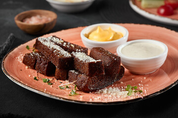 Rustic Garlic Borodinsky Croutons on a Pastel Platter with Dipping Sauces