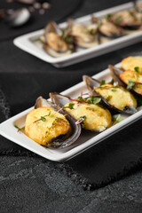 Delicious Baked Mussels with Cheese and Mussels in Sauce on Elegant Dark Background