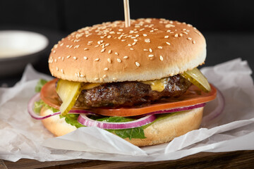 Delicious Beef Patty Burger with Fresh Ingredients in High-Contrast Lighting