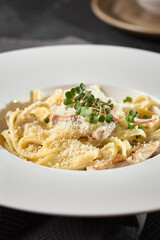 Creamy Chicken Mushroom Spaghetti with Parmesan on Elegant White Plate – Rustic Lighting and Warm Neutral Tones