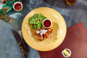 Delicious Buffalo Chicken Wings with BBQ Sauce on Rustic Ceramic Plate