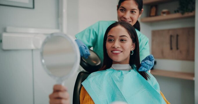 Woman, dentist and smile with patient on mirror for dental surgery in clinic with teeth whitening and treatment. Hygiene, satisfied and happy on consultation for canal procedure and oral care