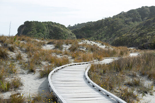 An old white bridge along the seaside at Monro Beach walk path. The trail end at the beach where can see Tawahi penguins breeding spot , West Coast, South Island, New Zealand.