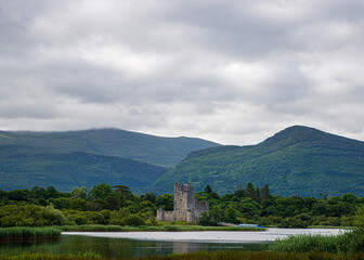 Fototapeta premium A castle is in the distance behind a mountain range