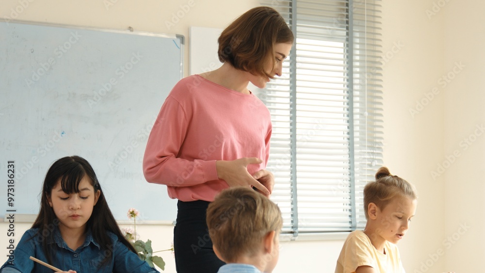 Poster energetic smart teacher explain classwork to caucasian boy at classroom while multicultural student 