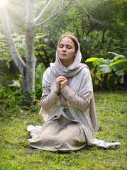 Young girl praying to God