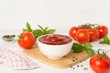 Delicious ketchup with spices and tomatoes on wooden table