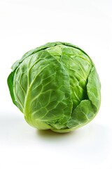 A fresh head of cabbage sits on a clean white surface, ready for use or display
