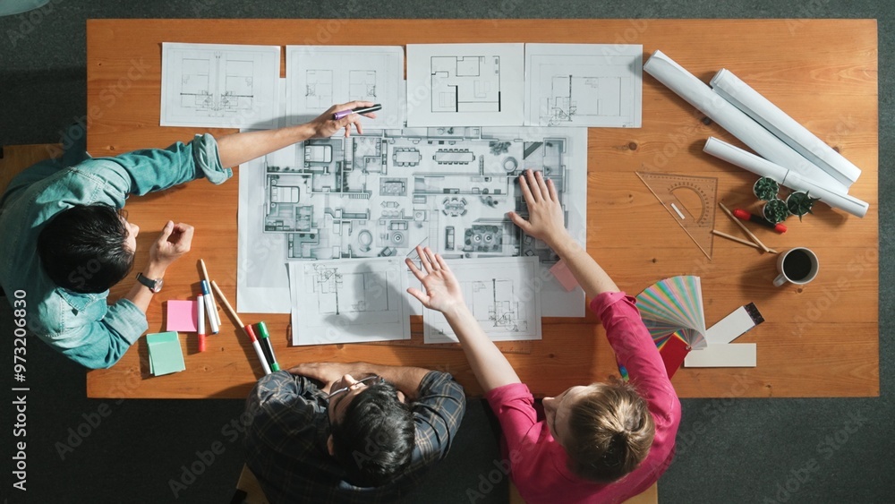 Poster group of people looking at blueprint while brainstorming idea. top view of engineer team looking and