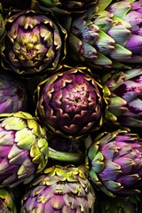 Obraz premium Top view of a bunch of ripe, colorful organic artichokes, highlighting their natural beauty variety