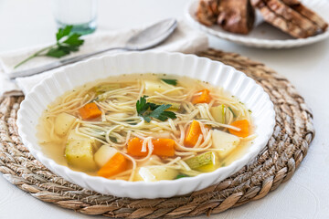 Homemade chicken noodle  and vegetables soup. 