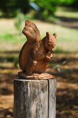 Wooden sculpture of a squirrel in a park
