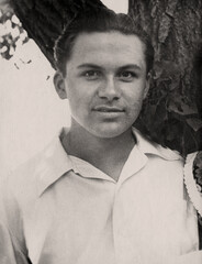 Retro portrait of a handsome young man in a white shirt. Vintage photo from 1955