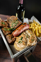 grilled chicken, beef, anticucho, chorizo and hot dog, served with french fries, fresh salad and a bottle of wine.