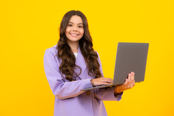 Young girl student hold computer. Funny pupil with laptop isolated on yellow background. Back to school.