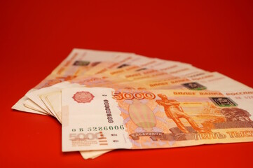 Russian rubles on a red background. Finance and economics.