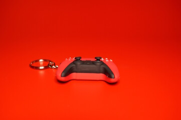 A toy joystick on a red background.