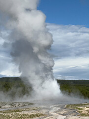 The eruption of Old Faithful in Yellowstone National Park spews steam hundreds of feet into the air