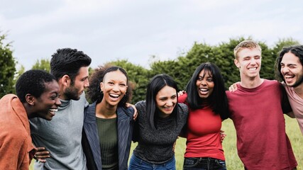 Fototapeta premium Diverse group of friends having fun smiling outdoor, Young people celebrate hugging together at park city
